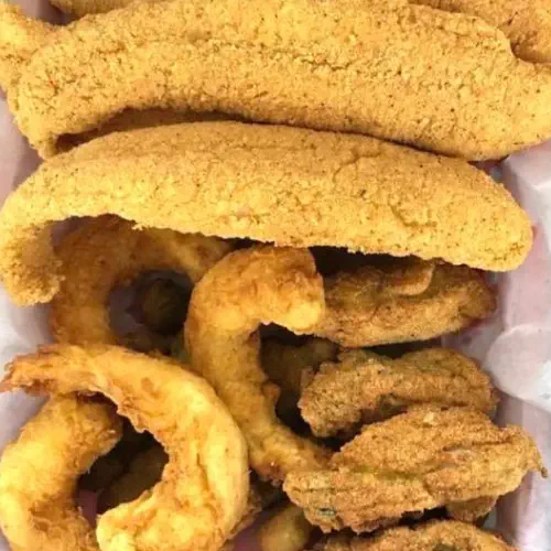 A tantalizing image of a seafood platter from Fish Frenzy, featuring an assortment of shrimp, fish, and shellfish beautifully arranged on a bed of ice.